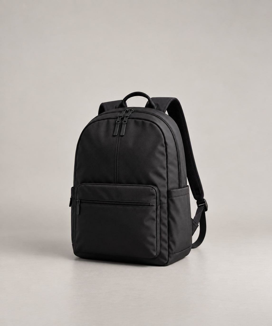 Black backpack photographed in a studio